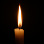 photo of the top a an candle burning in a dark room