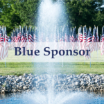 Blue Sponsor Banner overlaid a photos of a field of grass with American Flags waving behind a spouting fountain in a pond